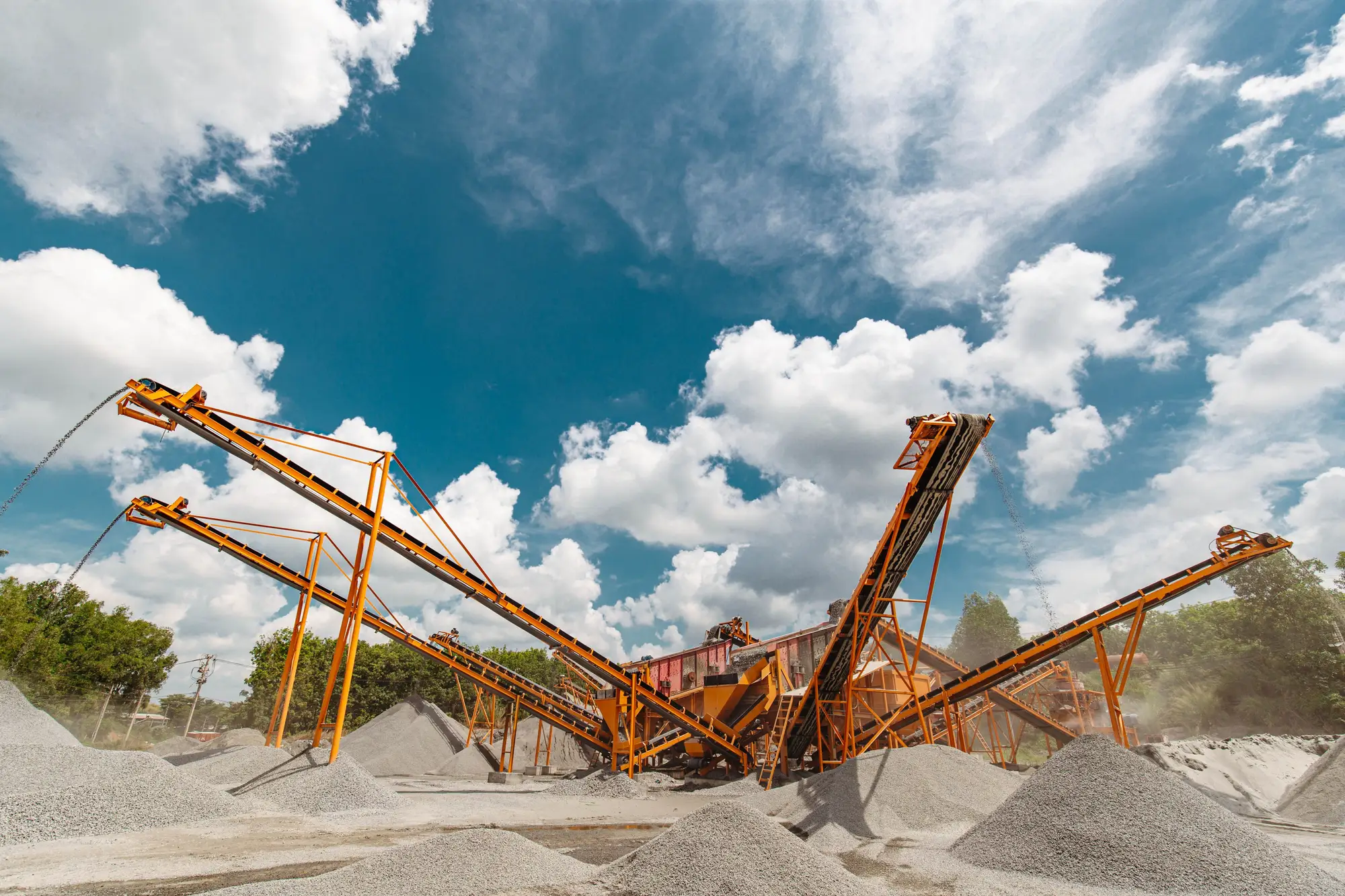 Conveyors and crushed-stone stockpiles at an aggregates plant